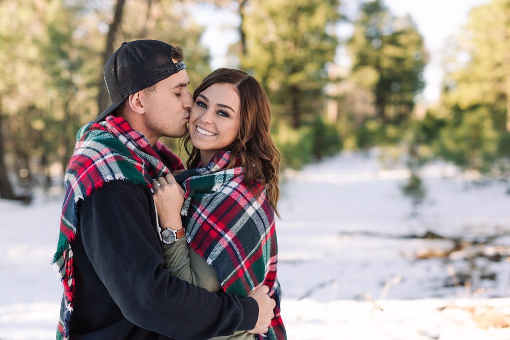 Snowy engagement photos with blanket