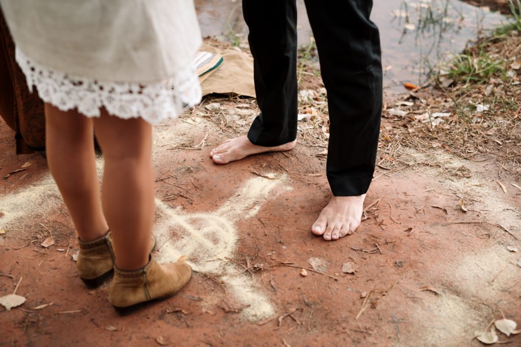 sedona Groom stands barefoot at elopement