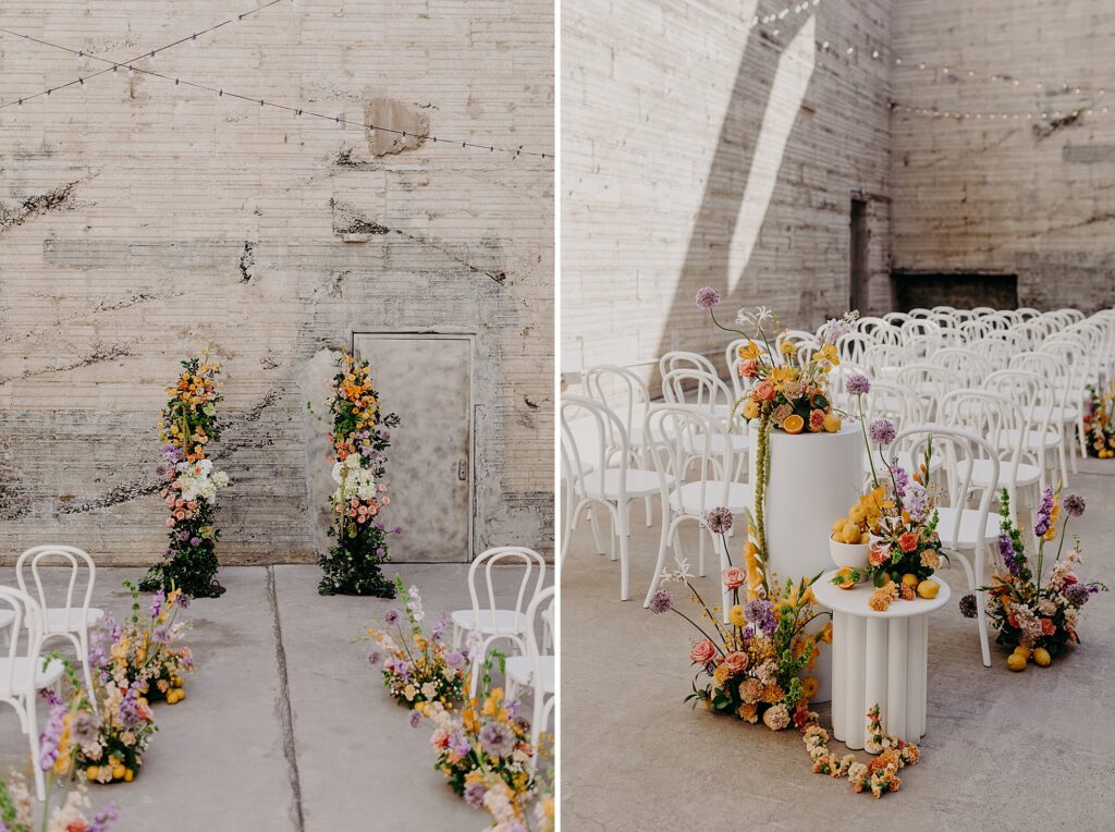 colorful floral archway in front of beige brick wall