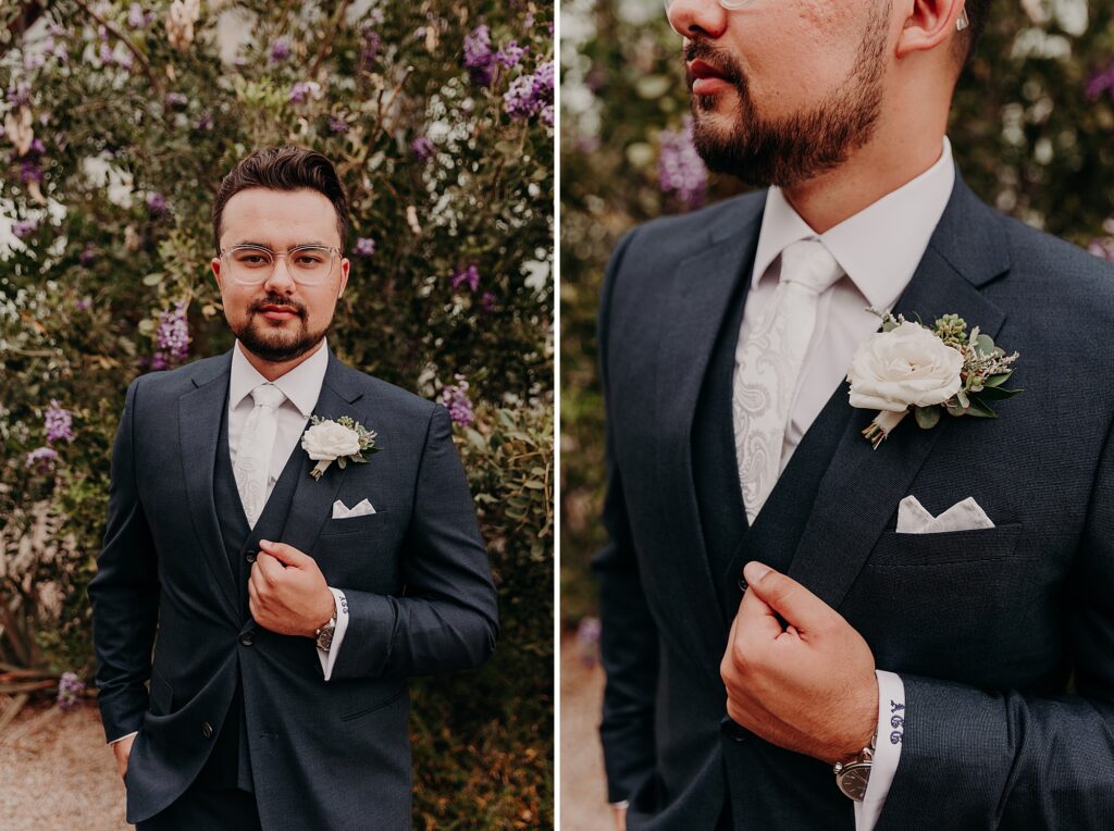 groom poses with hand on jacket on his wedding day