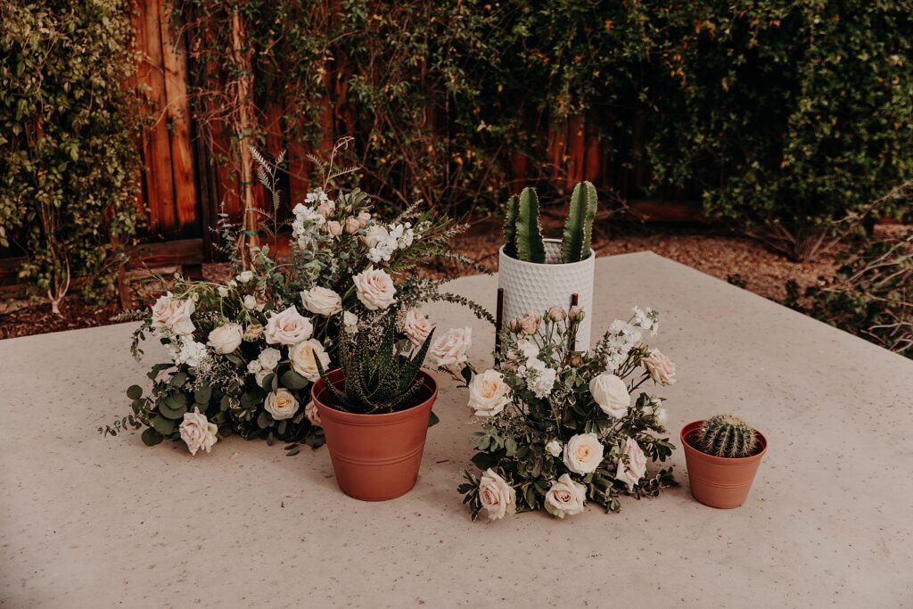 flowers and cactus styled on an altar for wedding ceremony