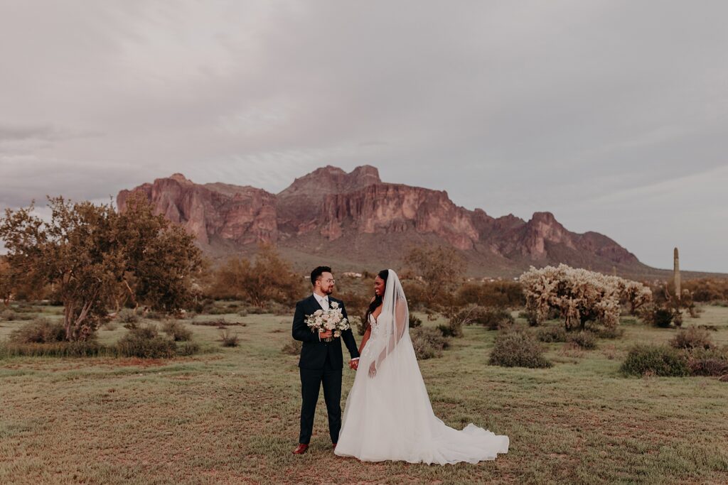bride and groom pose for sunset portraits at the paseo
