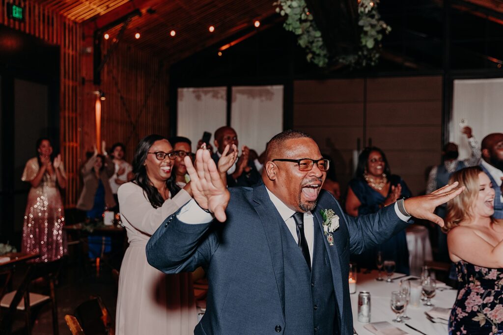 father of the bride excited at wedding reception