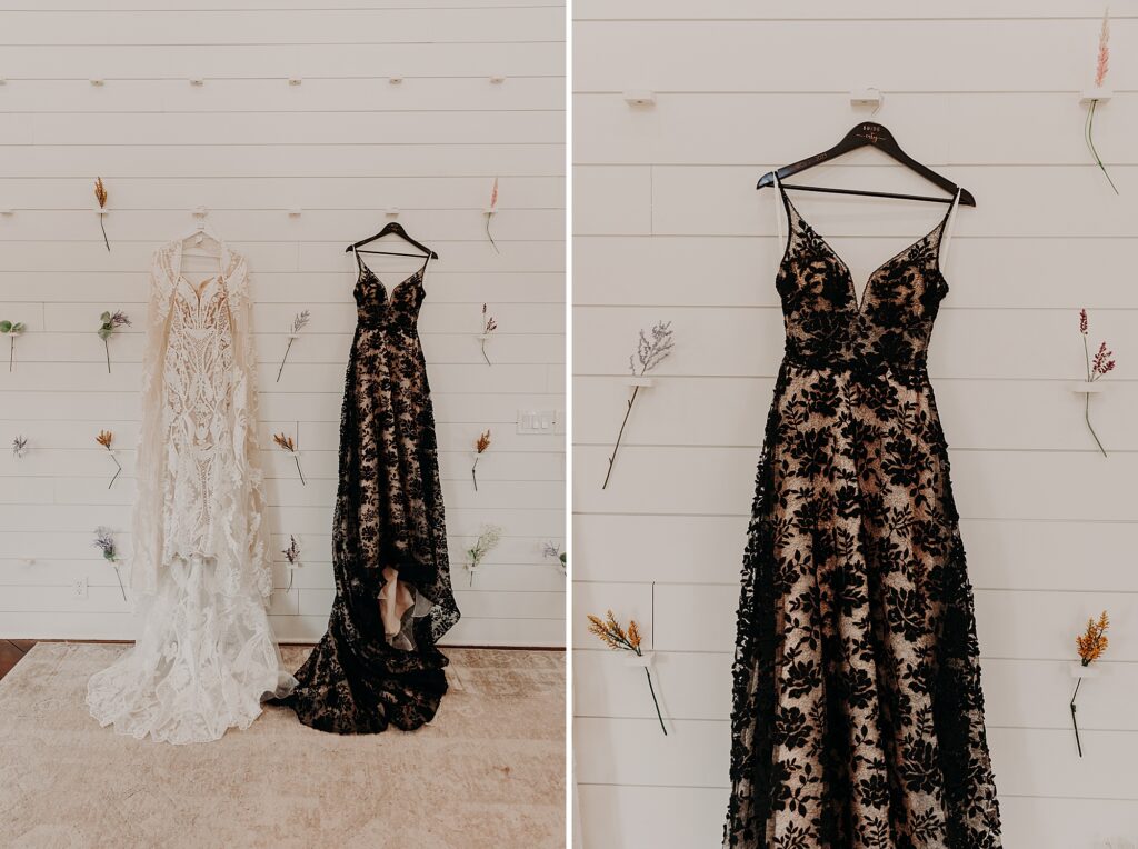 Two wedding dresses hung up together, one is black and one is white