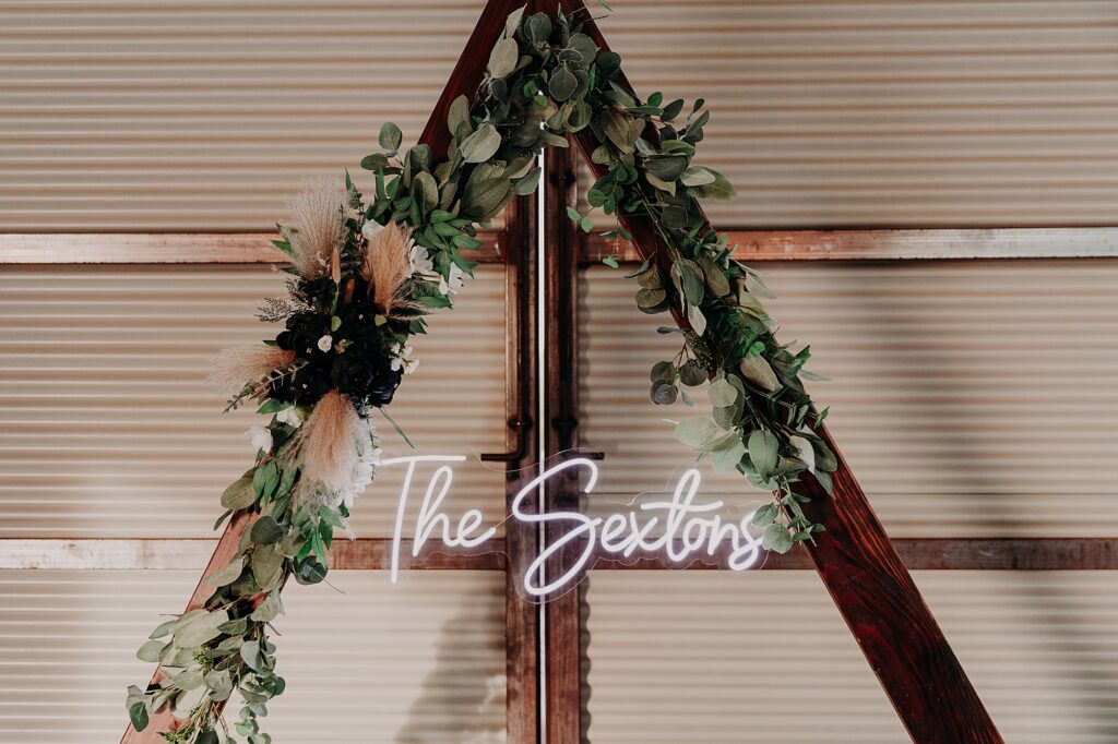 triangular arch at head table with neon light