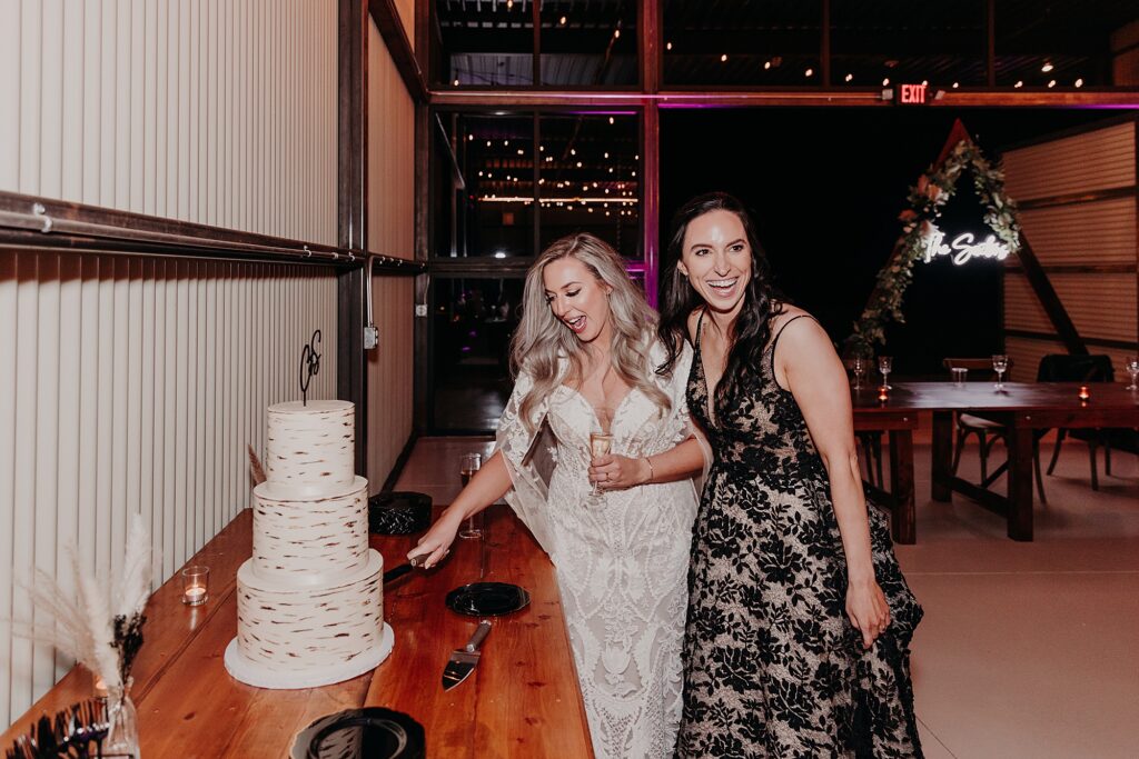 two brides cutting their wedding cake