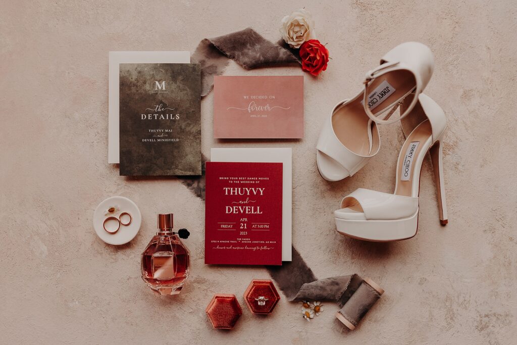 wedding invitation, jimmy choo shoes, and accessories styled together