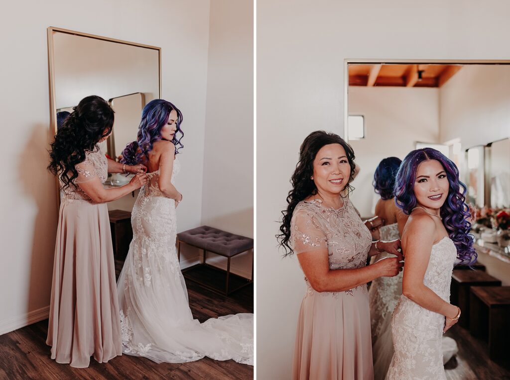 bride's mother helps bride get into wedding dress