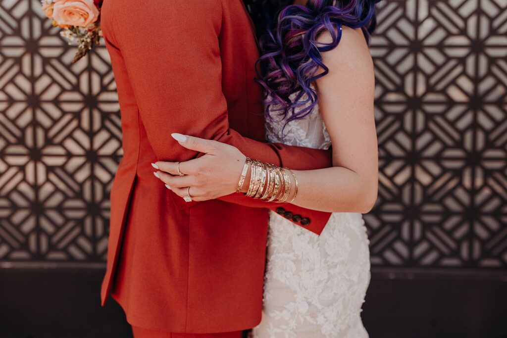 close up photo of bride and groom hug with bride wearing bangles