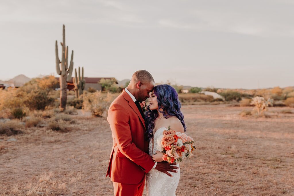 Bride and Groom hug romantically in the desert