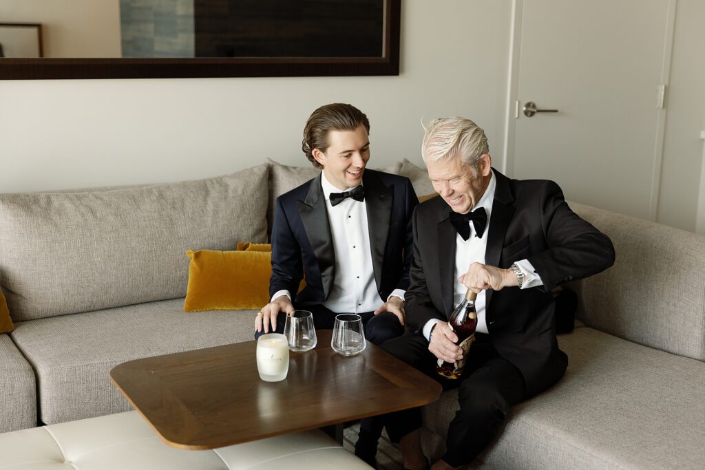 groom and his father share whiskey toast on wedding day