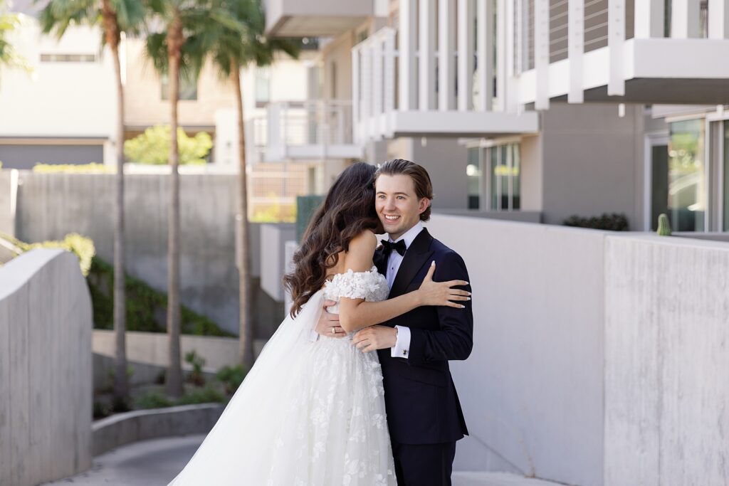 bride and groom embrace after seeing each other on their wedding day