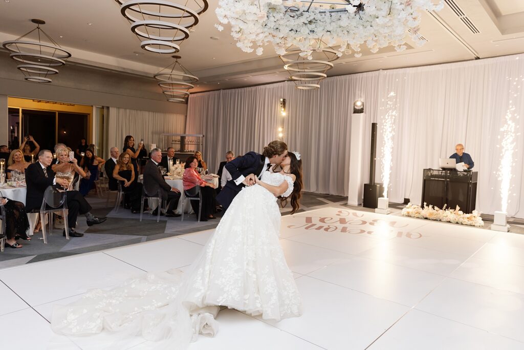 groom dips bride on the dance floor with cold sparks