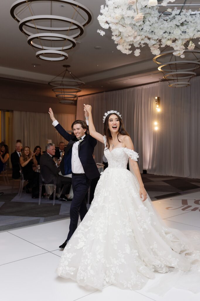bride and groom cheer after first dance