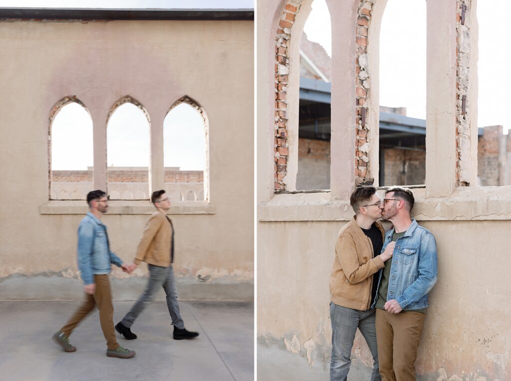 LGBTQAI+ couple walk together hand in hand in front of stone arches at Monroe Street Abbey in Phoenix.