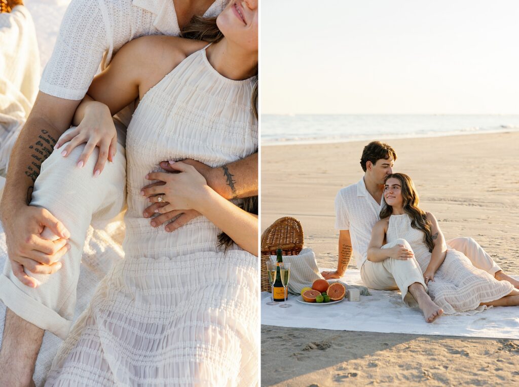 couple cuddle together on a picnic blanket on the beach at sunset