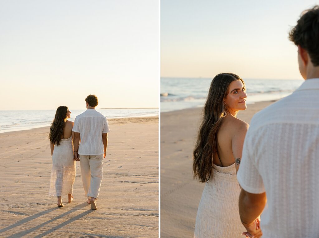 couple walk together on the beach at sunset