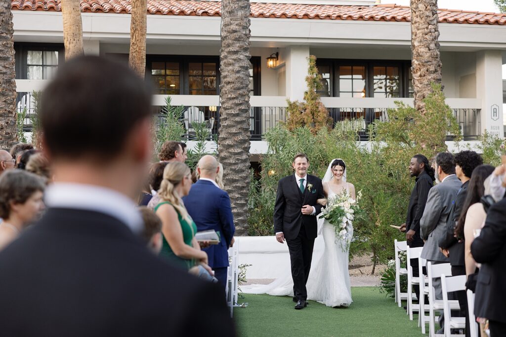 Bride walks down the aisle during wedding ceremony at the Scott Resort and Spa.