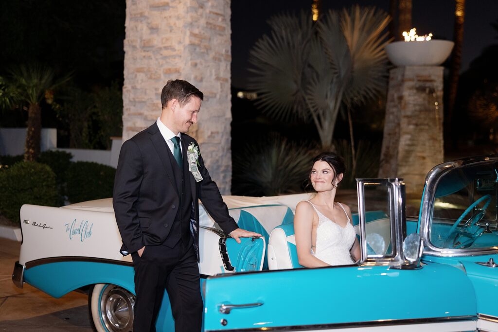 Bride and groom pose with vintage car at the Canal Club at the Scott Resort and Spa.
