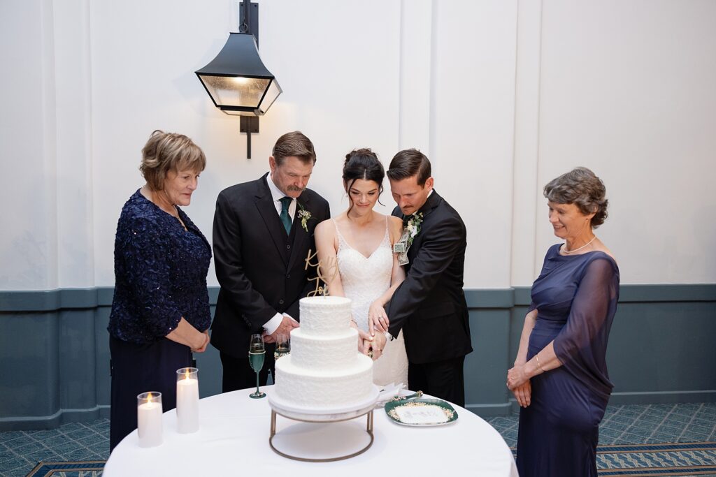 Bride and groom cut the cake at their wedding reception at the Scott Resort and Spa.