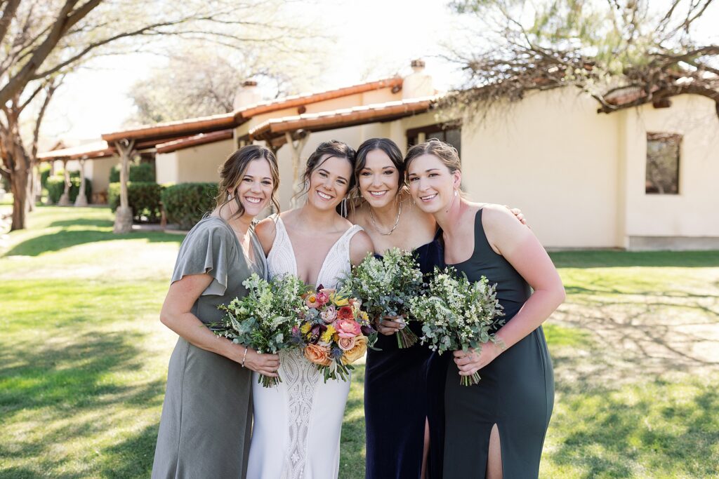 Bride smiles with their wedding party at Tubac Resort and Spa.