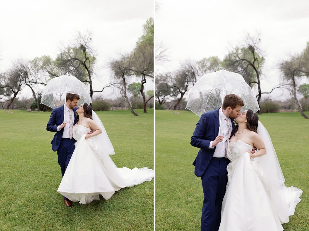 bride and groom walk together on rainy day and kiss under a clear umbrella