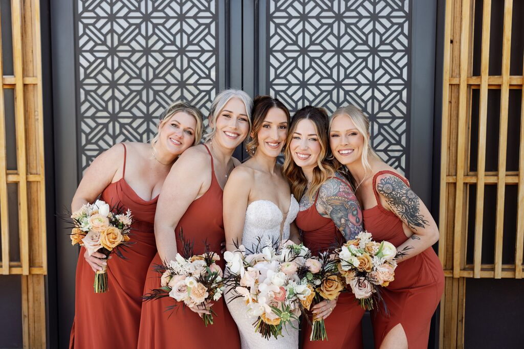 bride and bridesmaids gather and hug