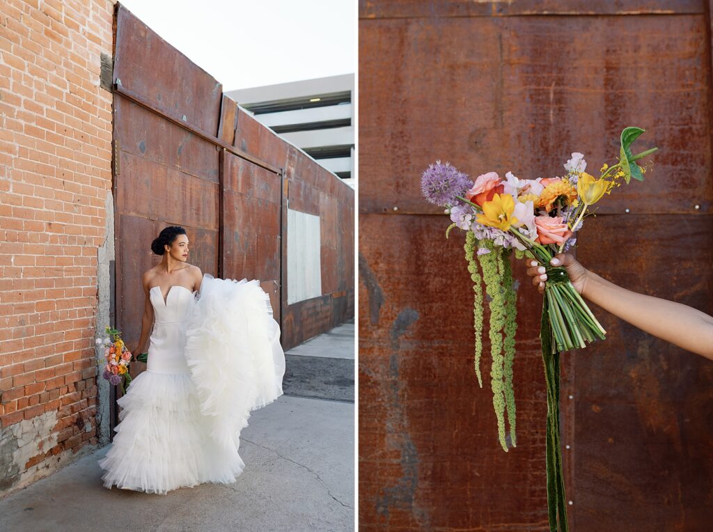 bride walkings in front of red industrial wall with colorful flowers