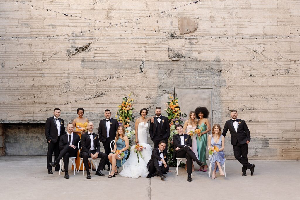 wedding party seated vogue style with bride and groom