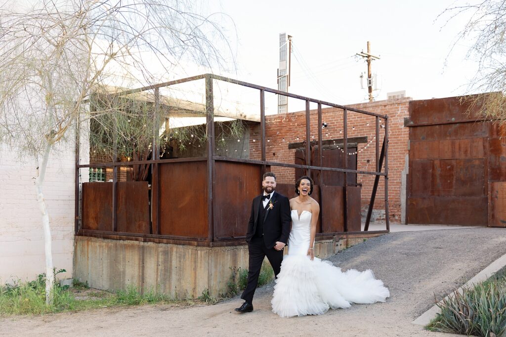 bride and groom enter reception holding hands