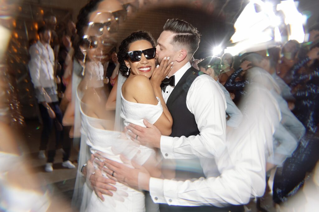 bride and groom hug on dance floor at wedding