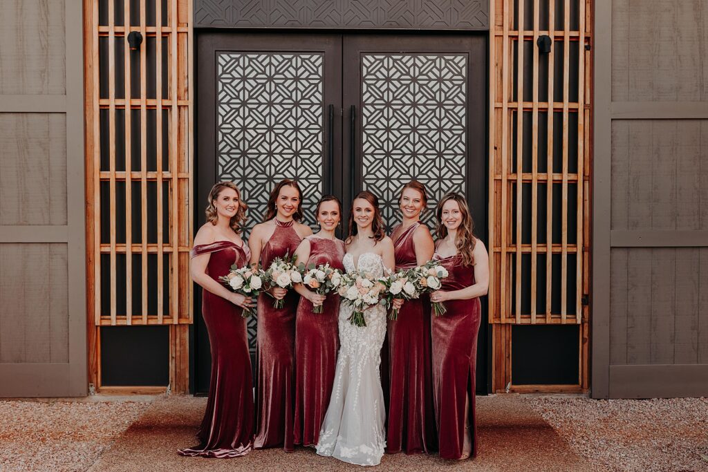 bride and her bridesmaids hold bouquets