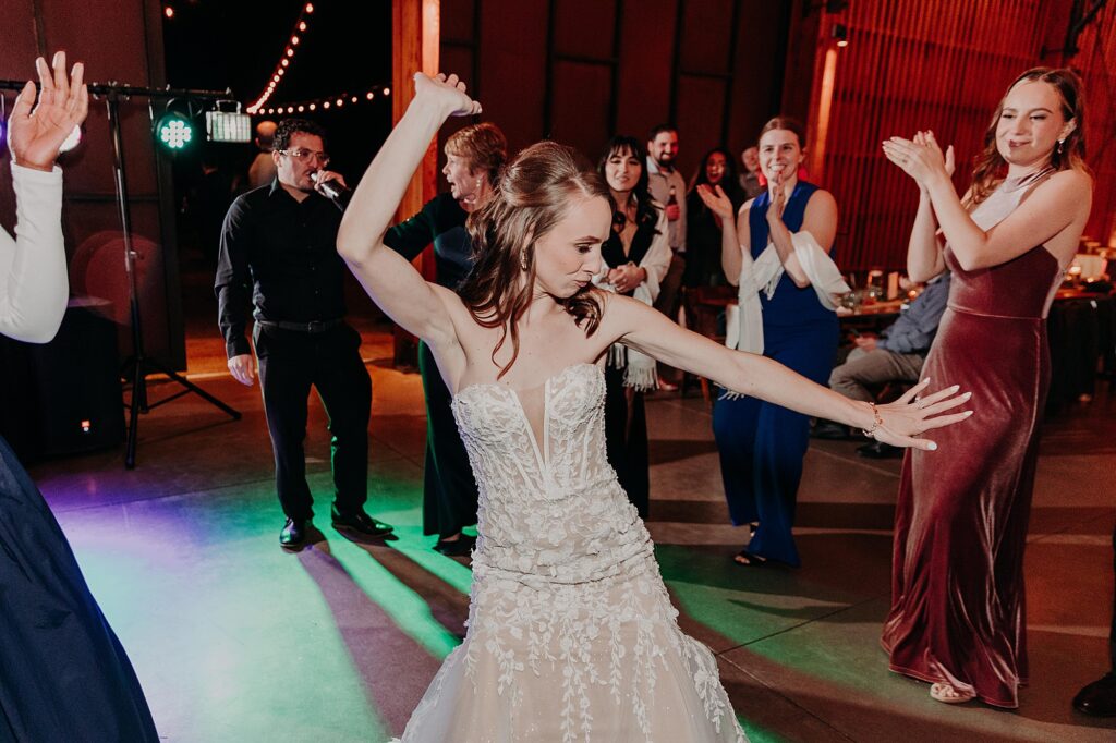 bride and groom share fun dance moves during wedding reception