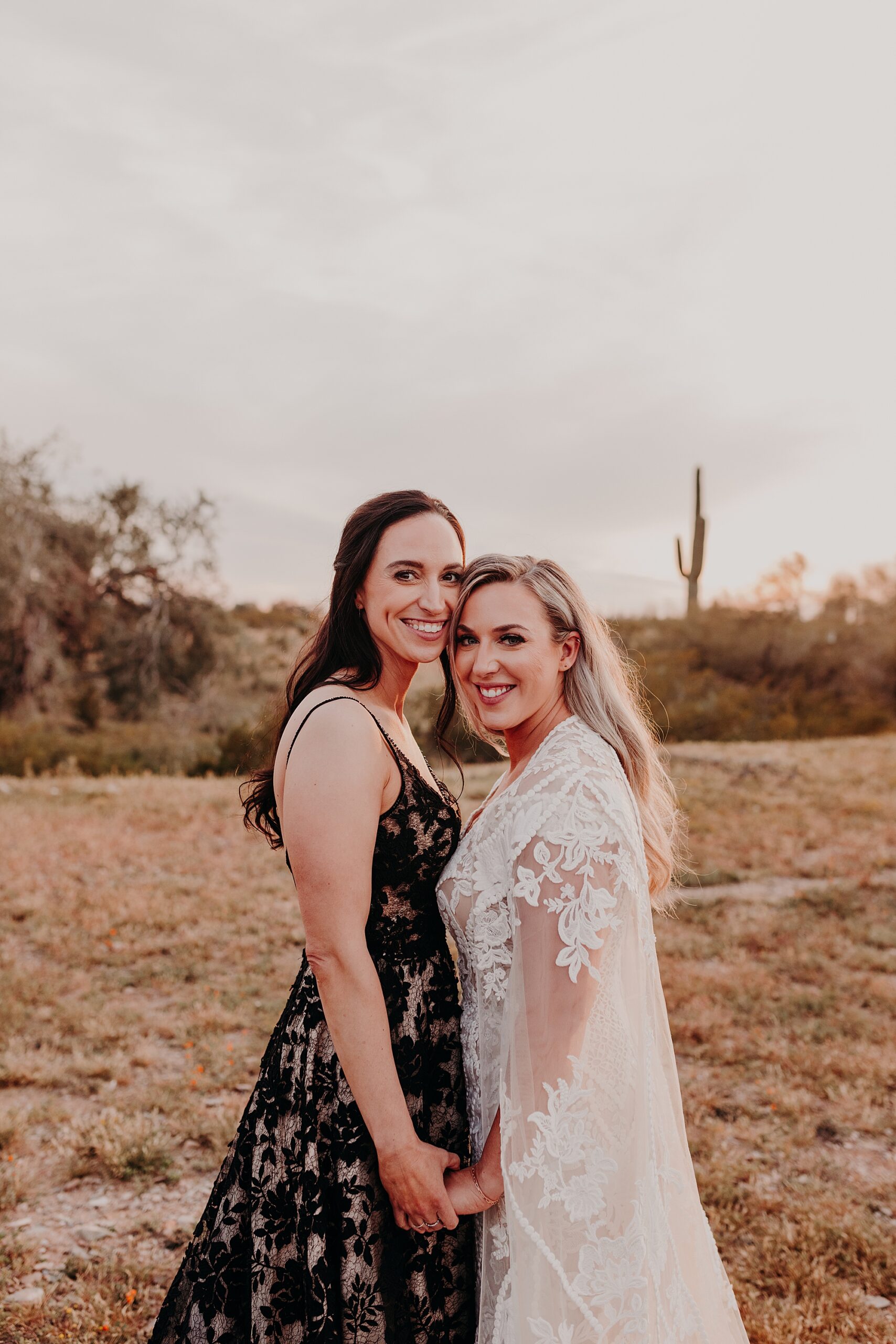 Two brides in the desert with black and white dresses