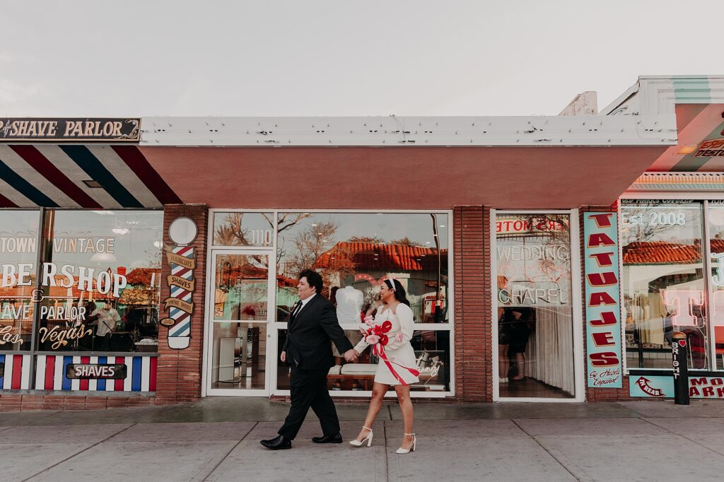 bride and groom walk together outside sure thing wedding chapel in vegas