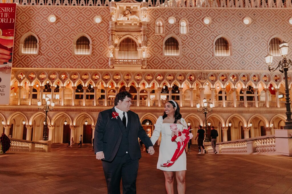 couple explore the Venetian hotel at night with flash