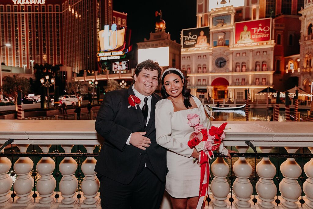 bride and groom cuddle on the vegas strip before wedding reception