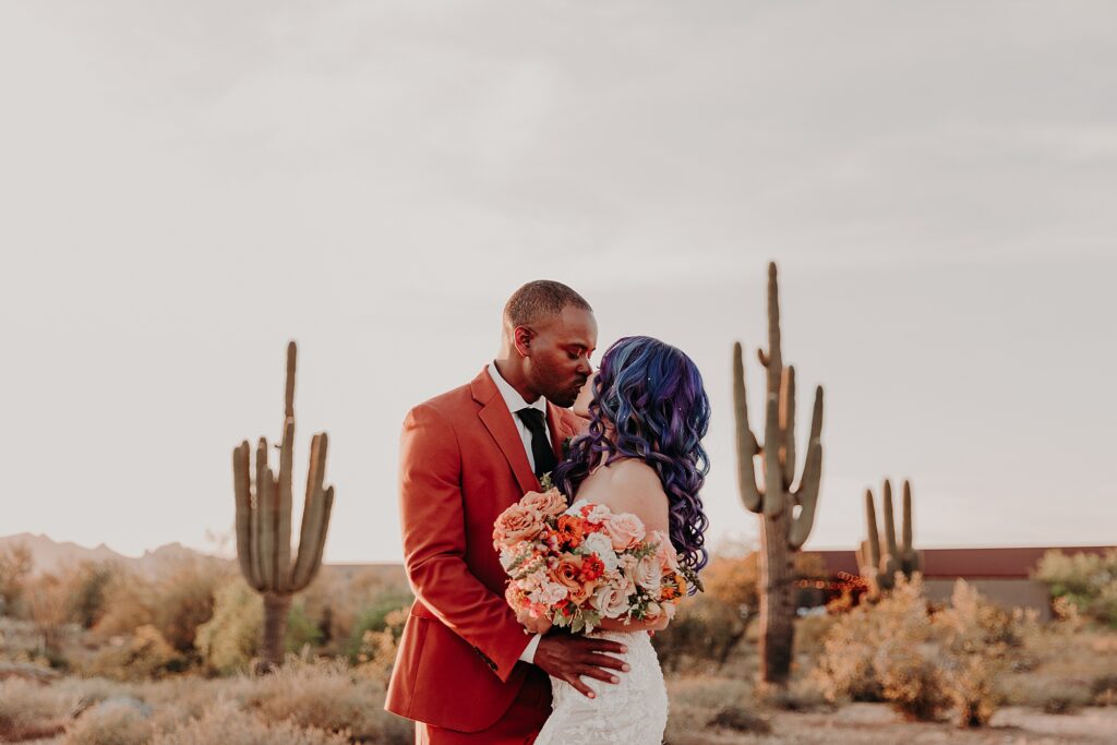 Bride and Groom hug romantically in the desert