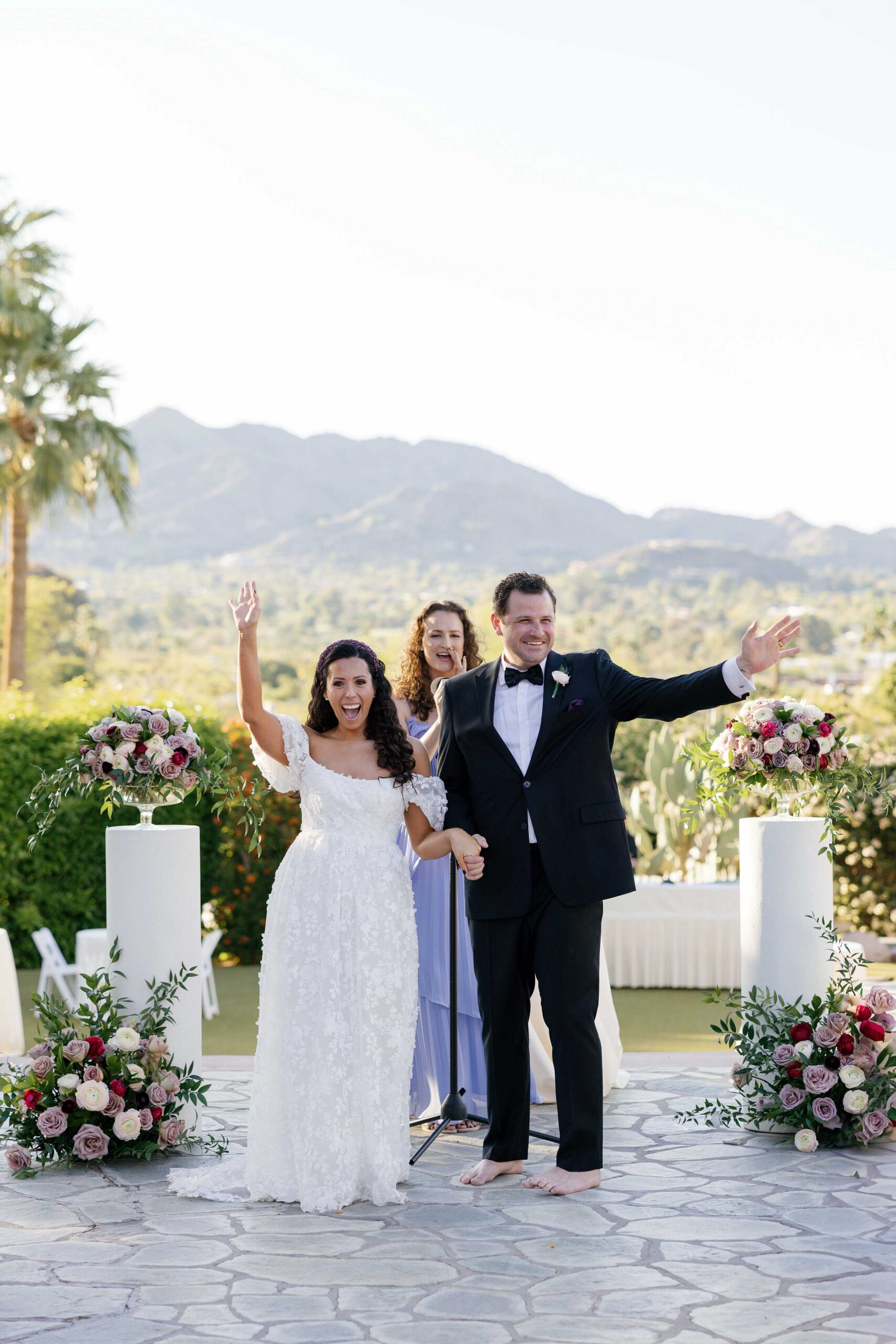 Bride and groom wave at guests during wedding ceremony at the Sanctuary in Paradise Valley Arizona
